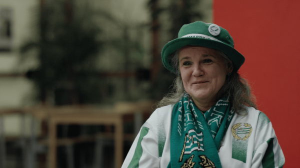 Woman with green hat and scarf